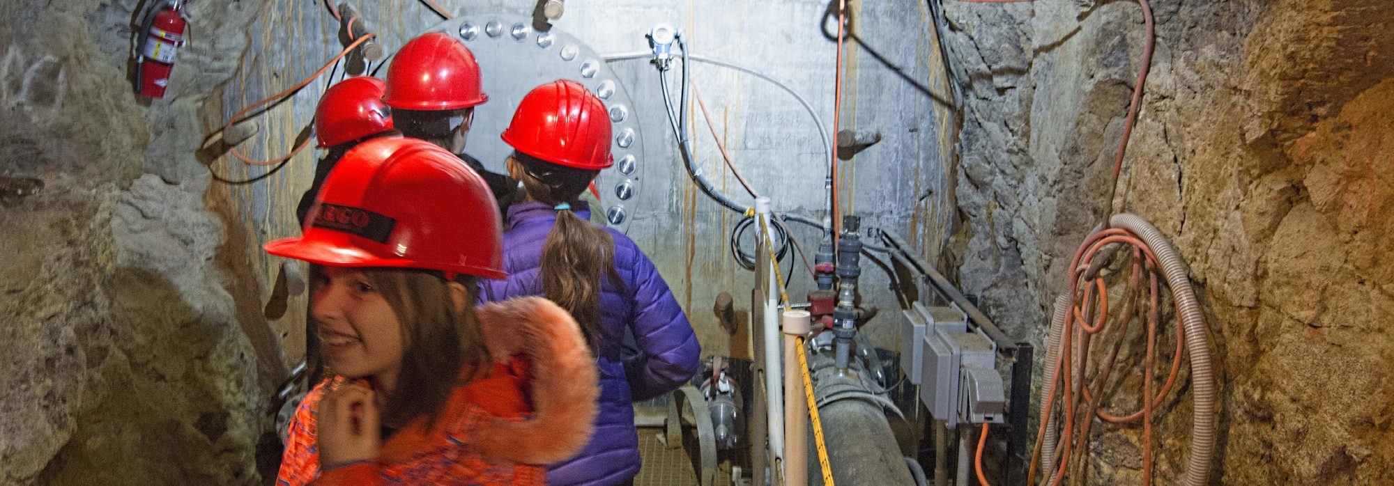 A guide leading a group through the Argo Mill