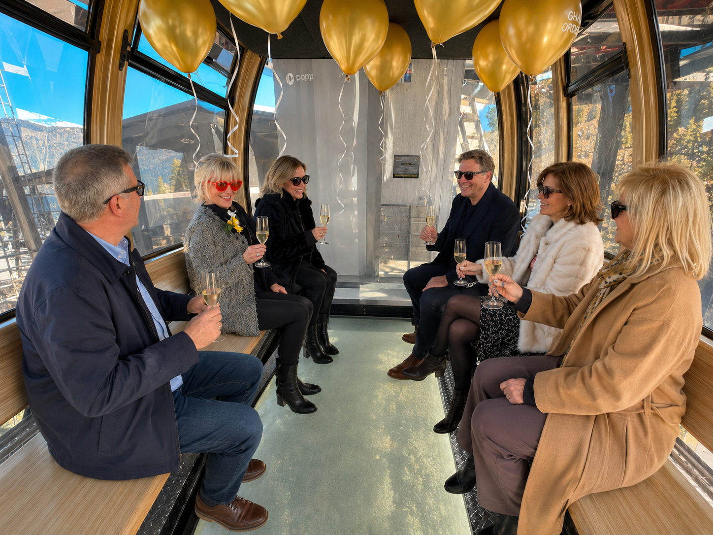 A private group riding up in a cabin, champagne glasses raised